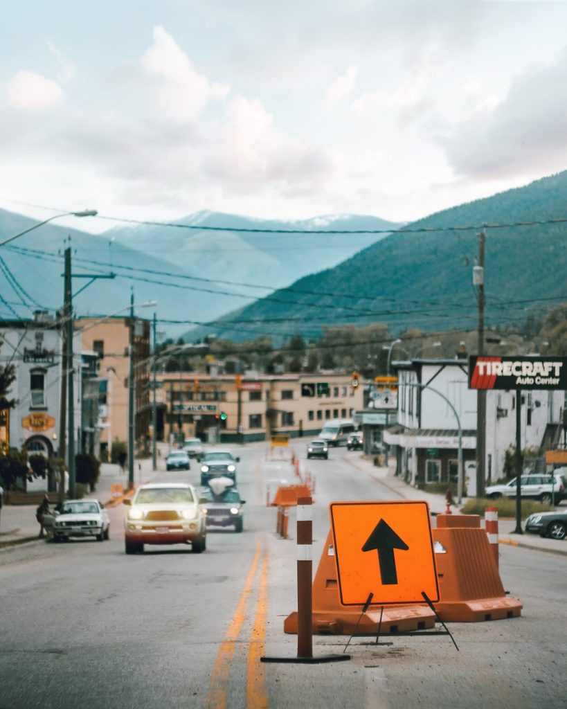 Cars driving on the road with a mountainous background