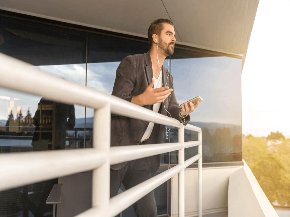 Man standing on the balcony while talking on the phone